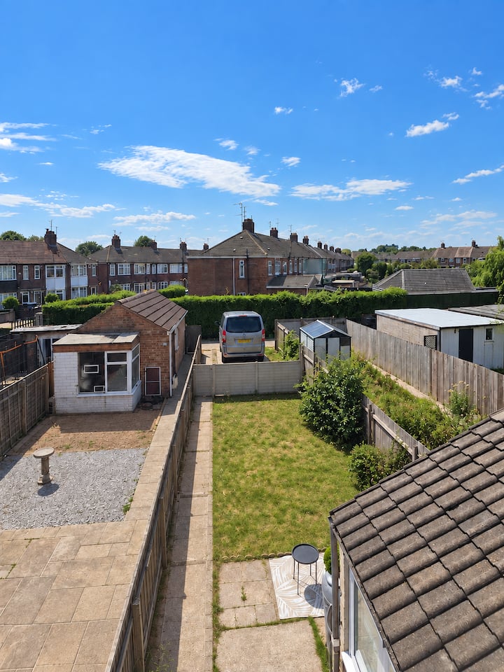 Rear garden with a van parked in the private rear parking area